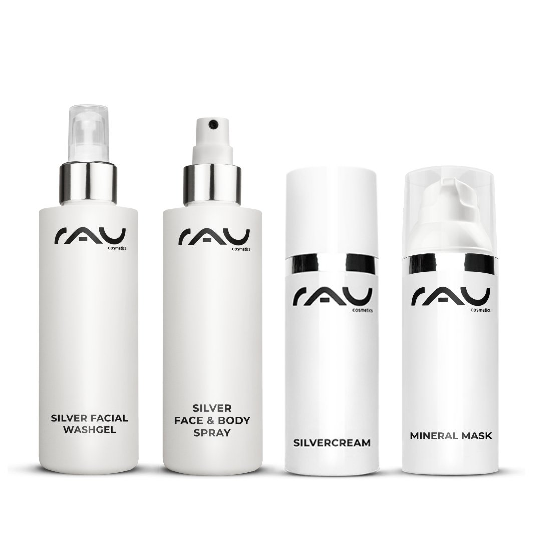 Routine de soin professionnelle pour la neurodermite de RAU Cosmetics, composée du gel lavant à l'argent, du spray argent visage et corps, de la crème à l'argent et du masque minéral, dans d'élégants flacons blancs avec logo noir.